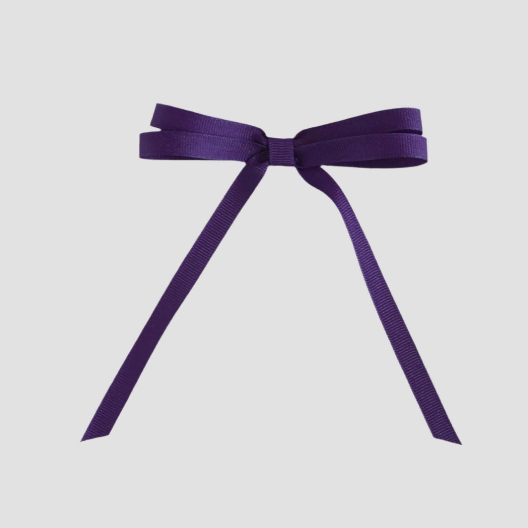 Purple ribbon bow on a white background