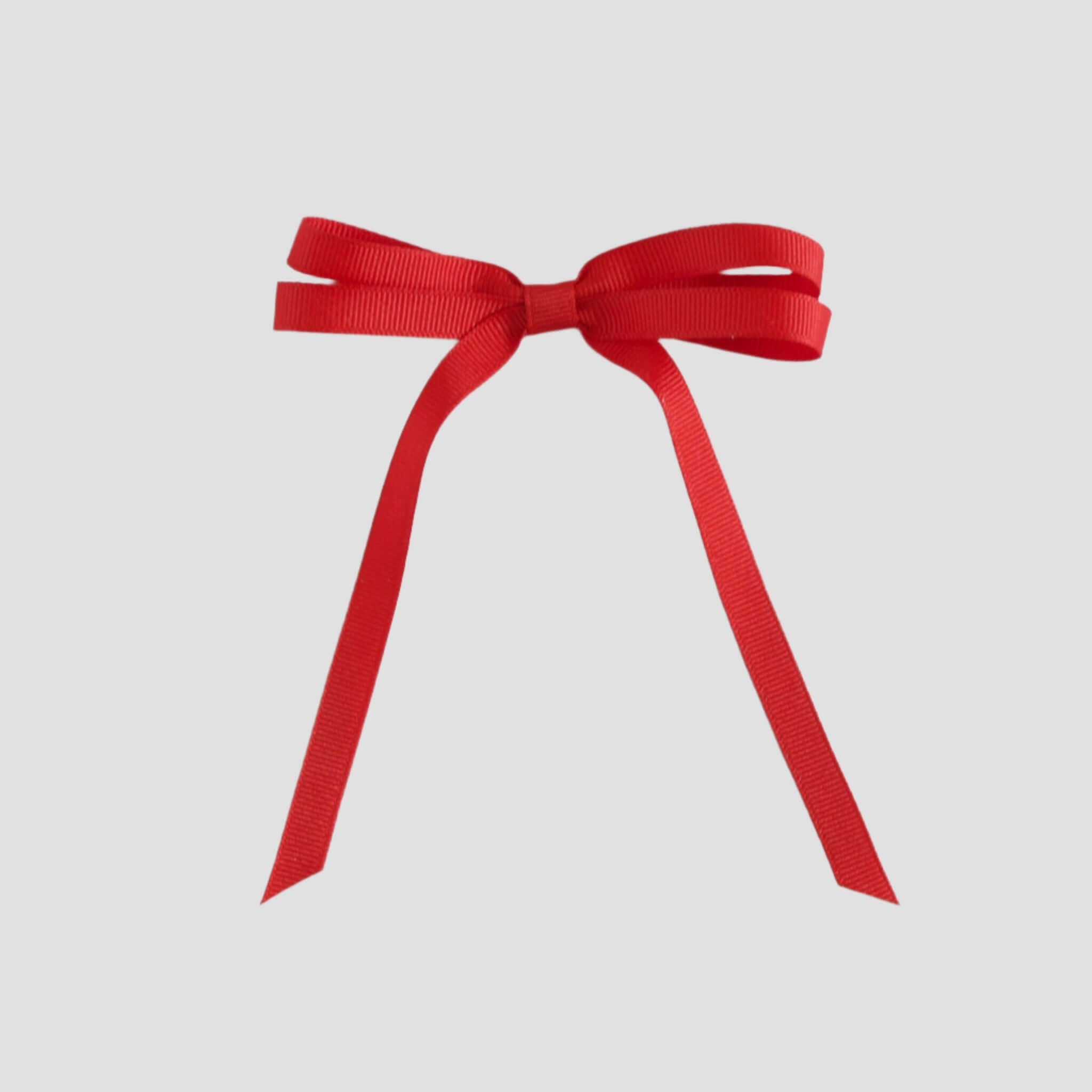 Red grosgrain ribbon bow on a white background