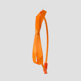A tangerine orange satin headband with a bow design in the center, displayed against a white background.