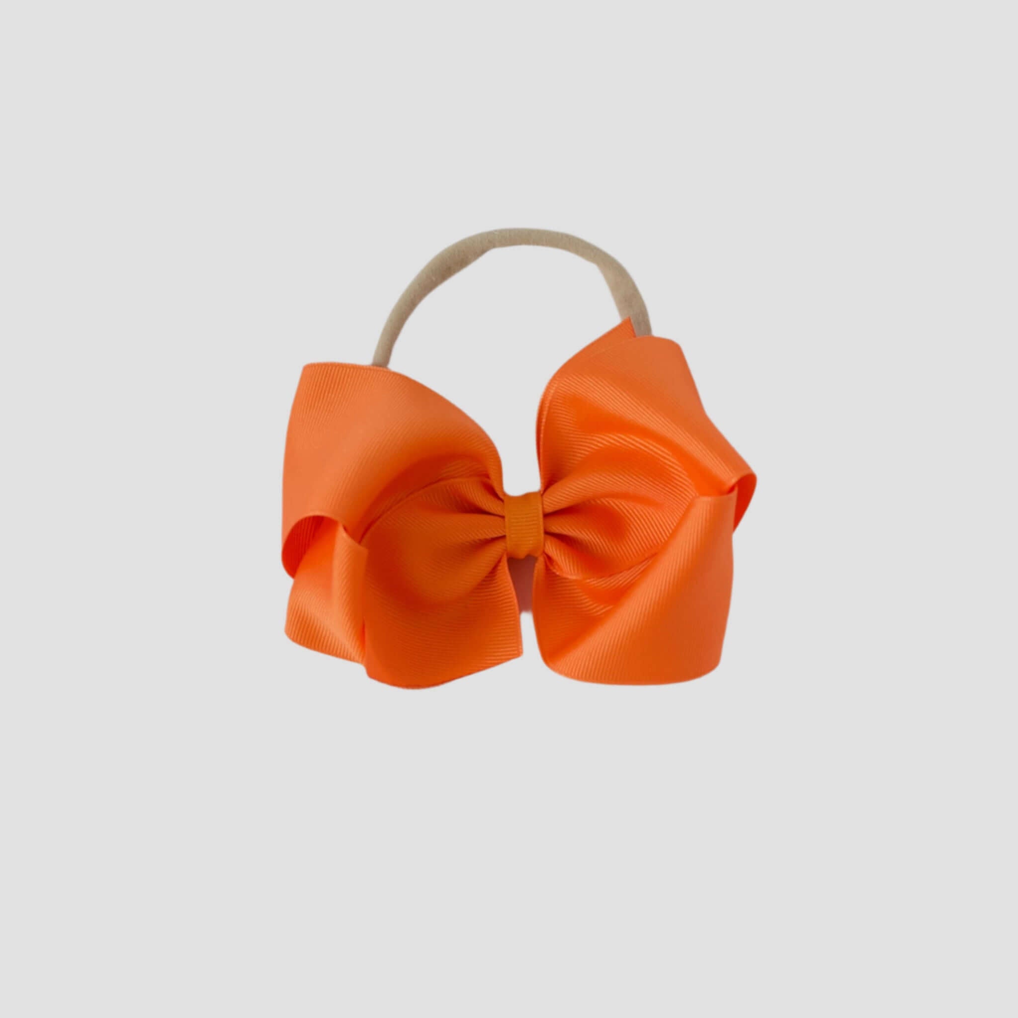5 inch Grosgrain Penelope hair bow Headband in ornage on a white background