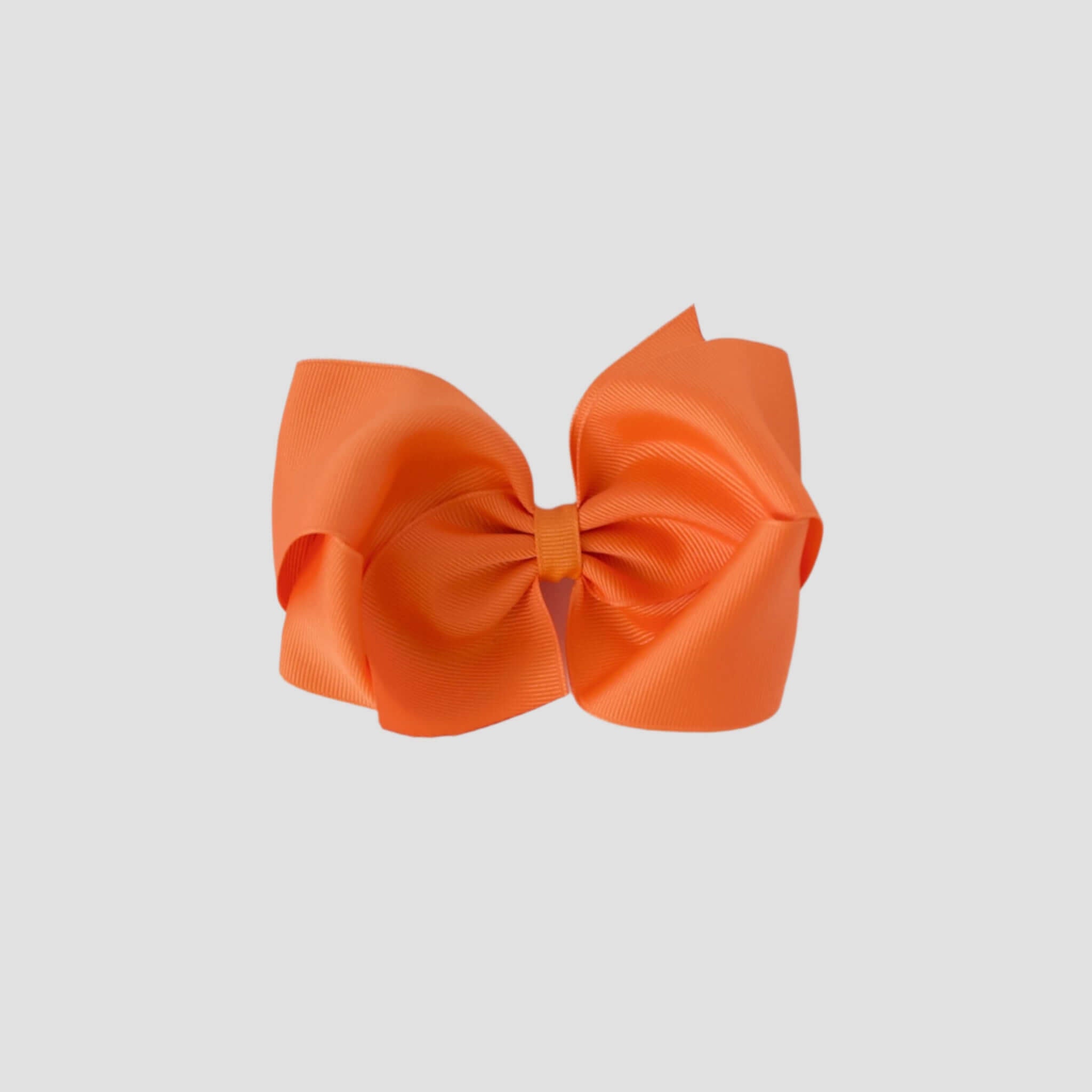 Orange hair bow on a white background