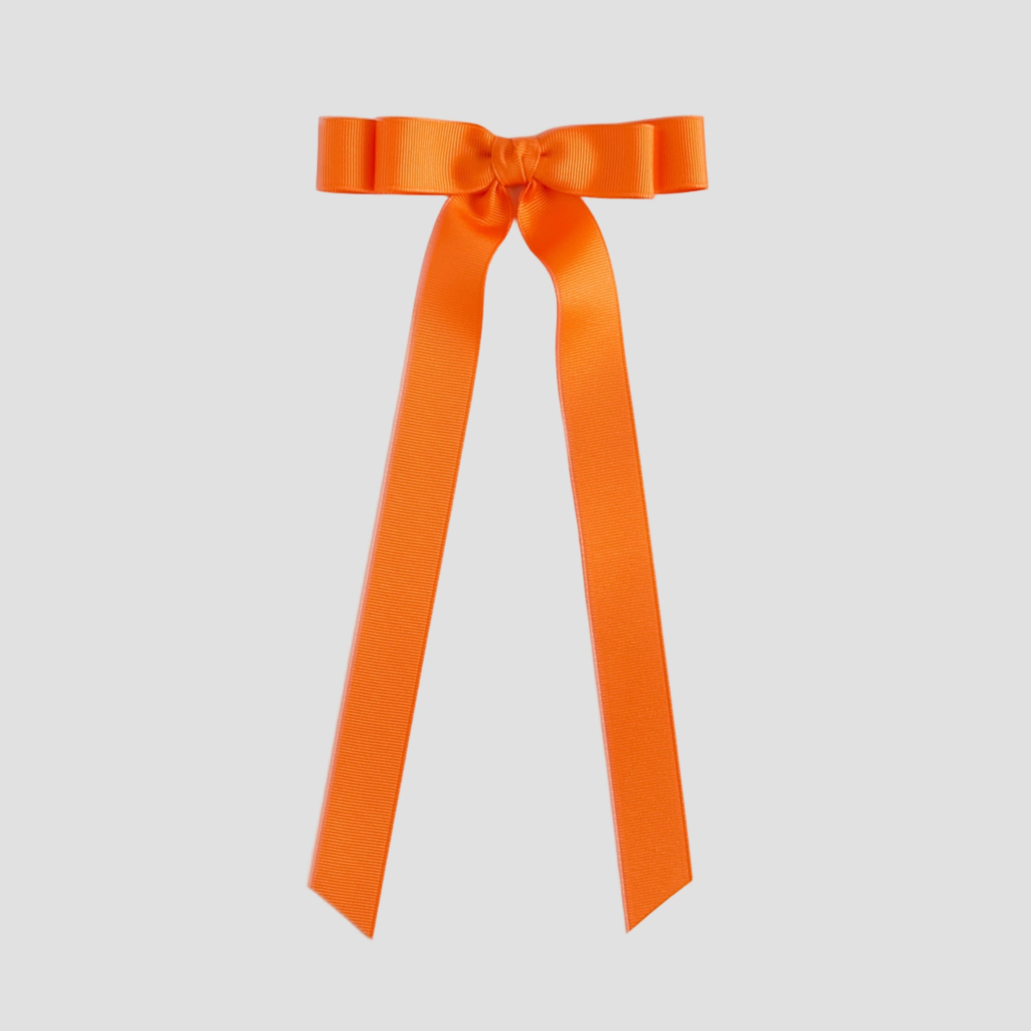 Orange ribbon bow on a white background