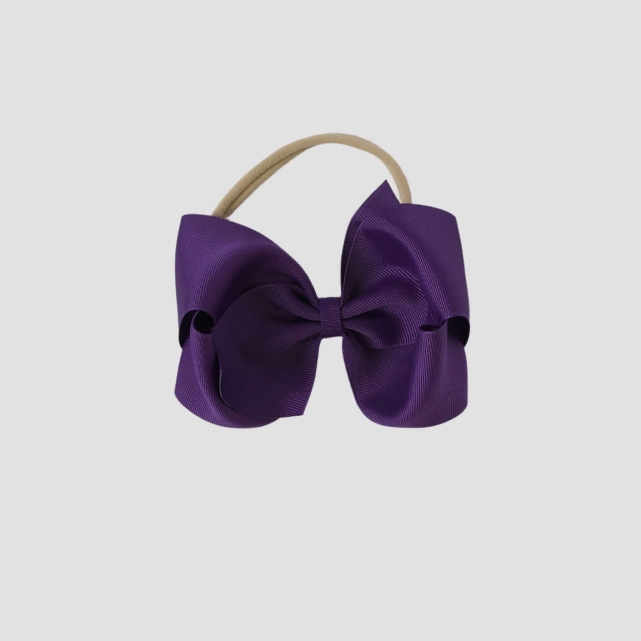 5 inch Grosgrain Penelope hair bow Headband in purple on a white background