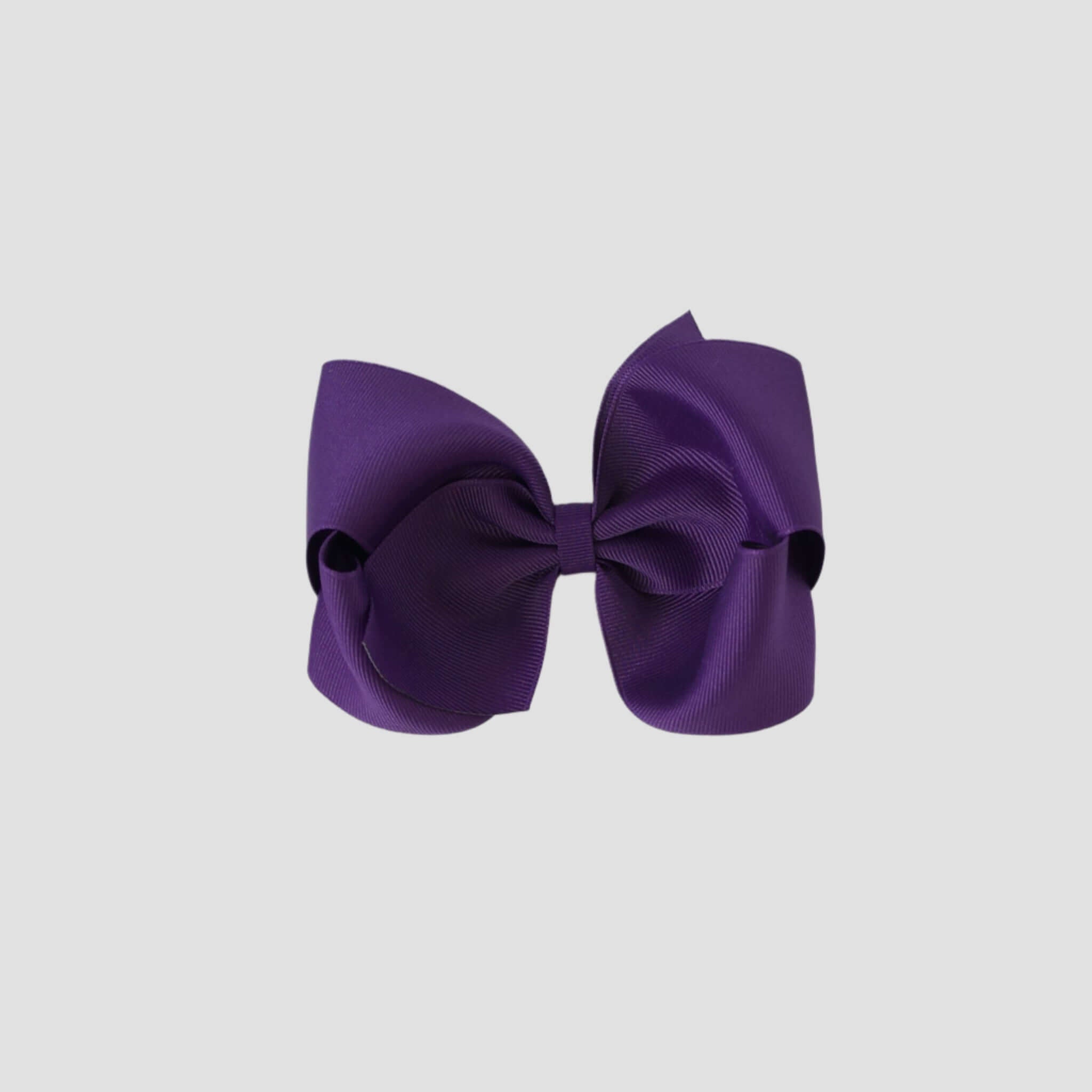 Purple hair bow on a white background