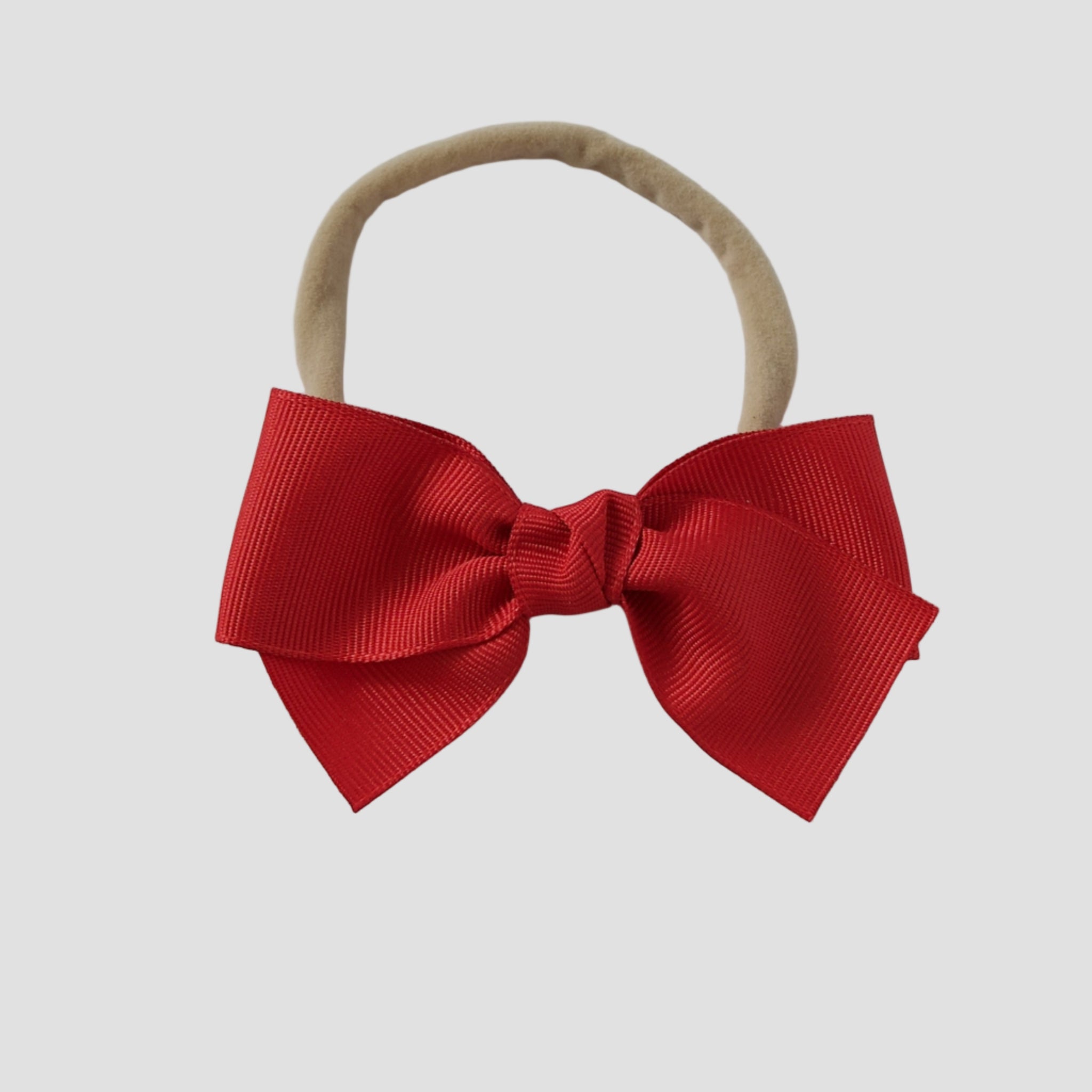 Red grosgrain bow on a ude nylon headband