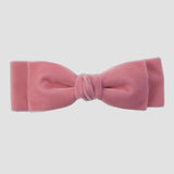 Rose pink velvet hair bow on a white background