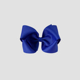 Royal blue hair bow on a white background