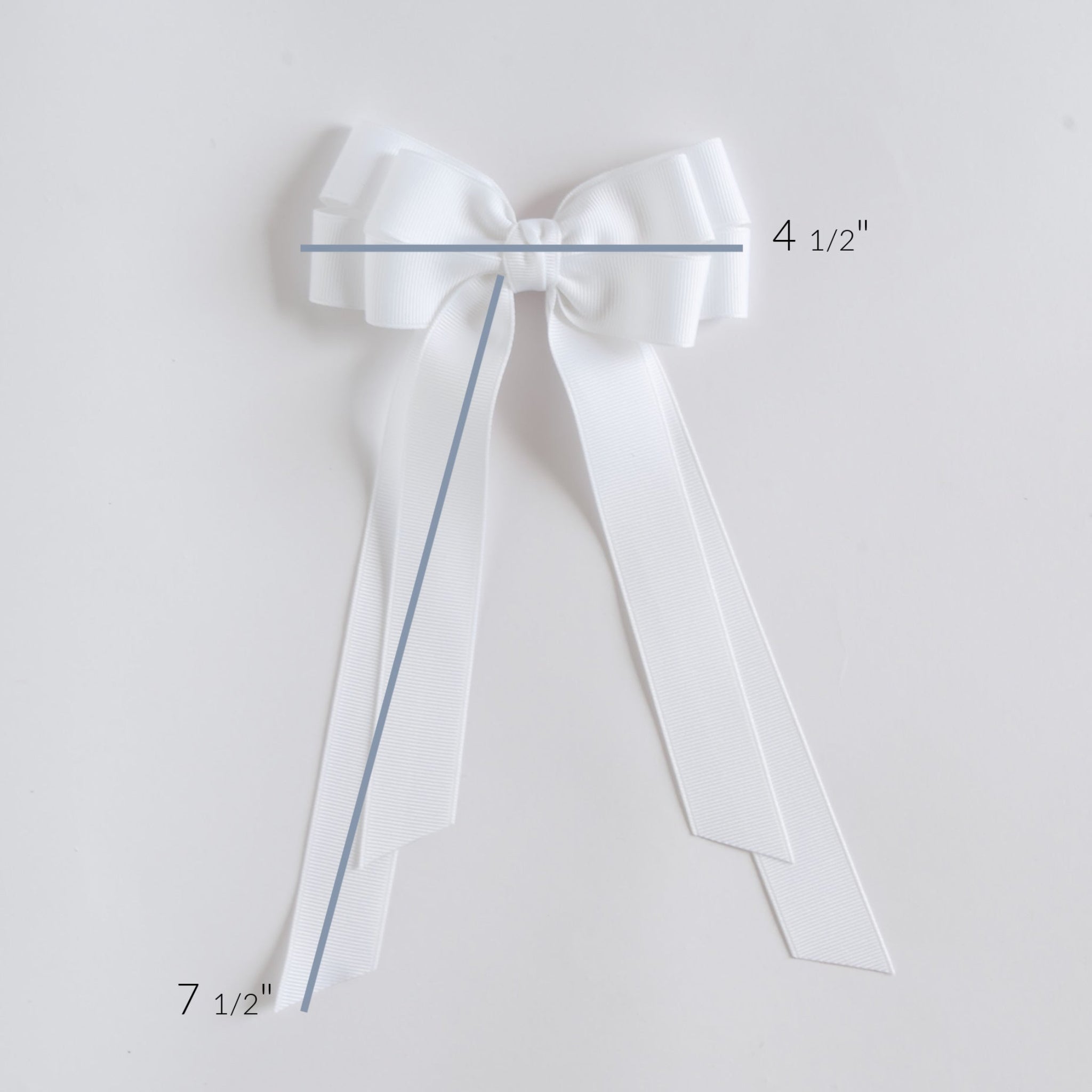 White bow with measurements on a light gray background