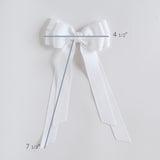 White bow with measurements on a light gray background