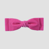 Hot pink velvet bow on a white background
