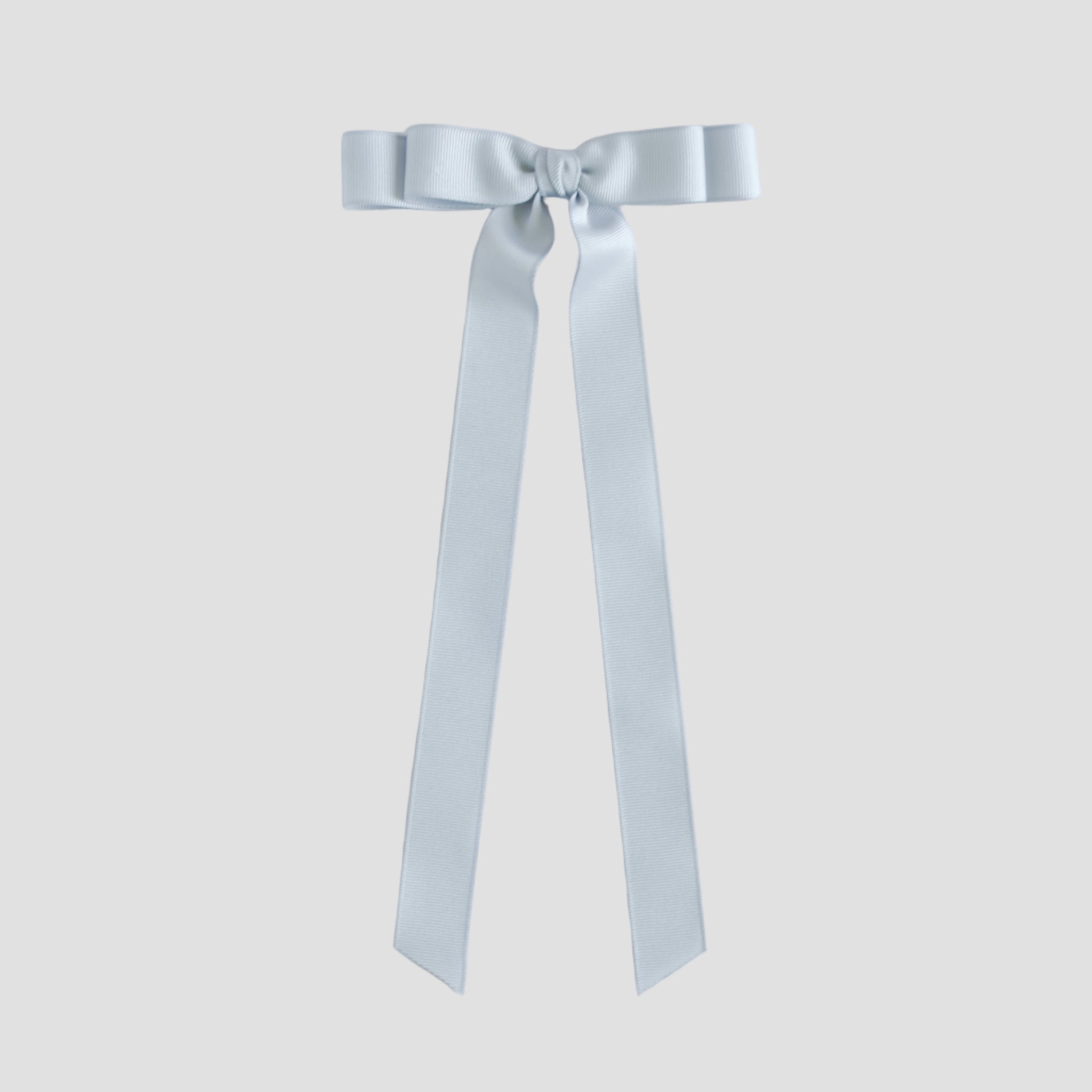 Silver grosgrain ribbon bow on a white background
