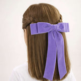 Young girls wearing lavender Grace velvet hair bow in a half up braid style