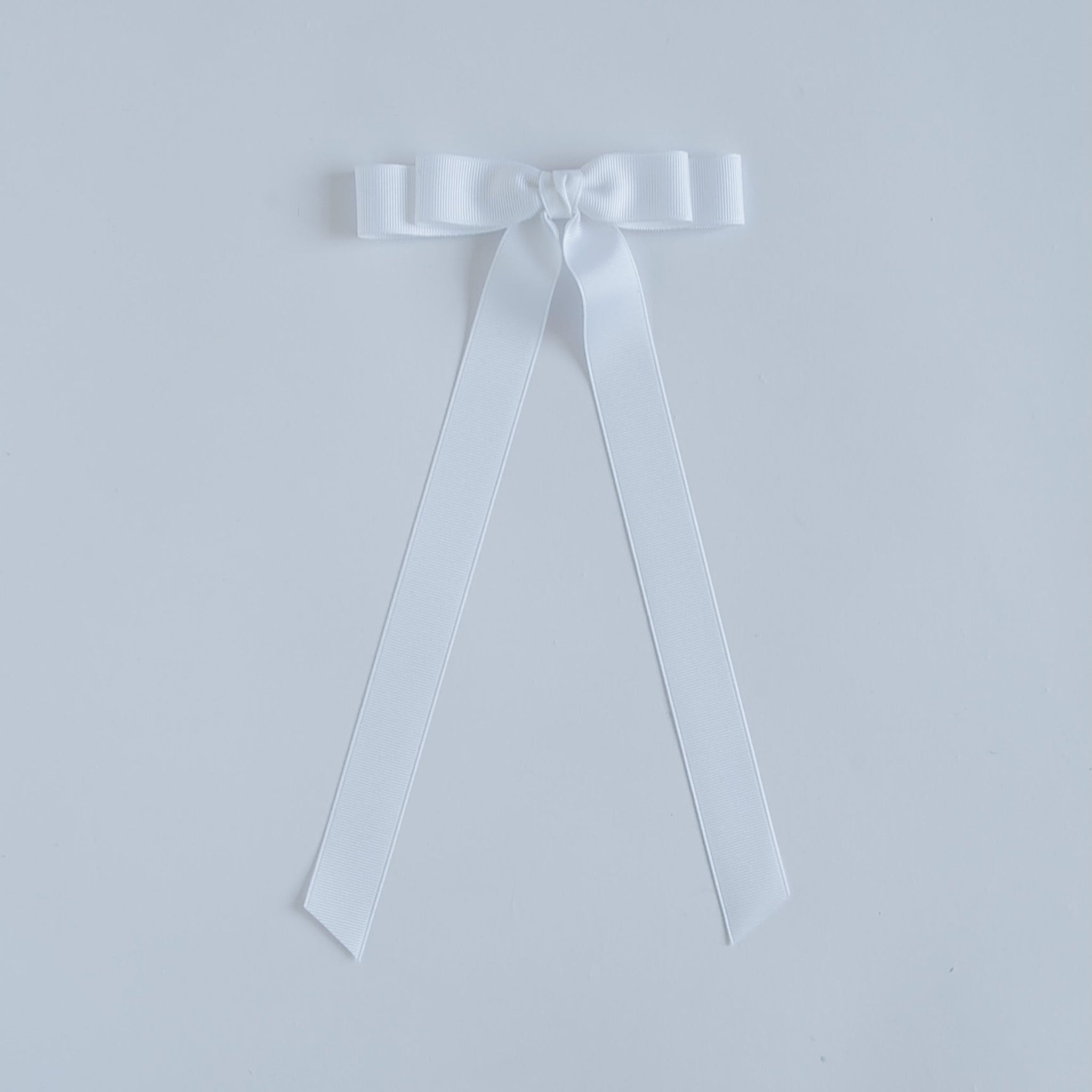 White ribbon bow on a white background