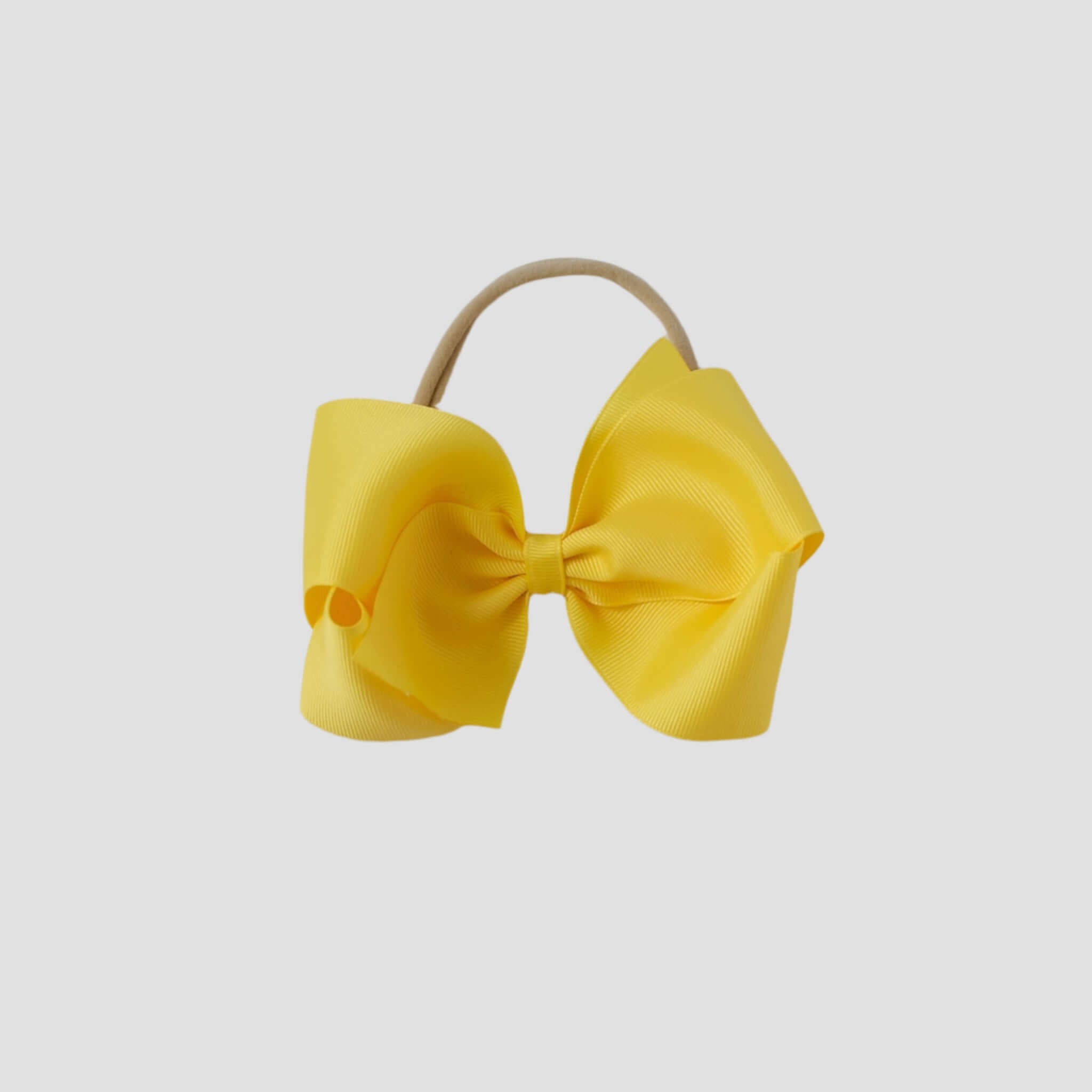 5 inch Grosgrain Penelope hair bow Headband in yellow on a white background