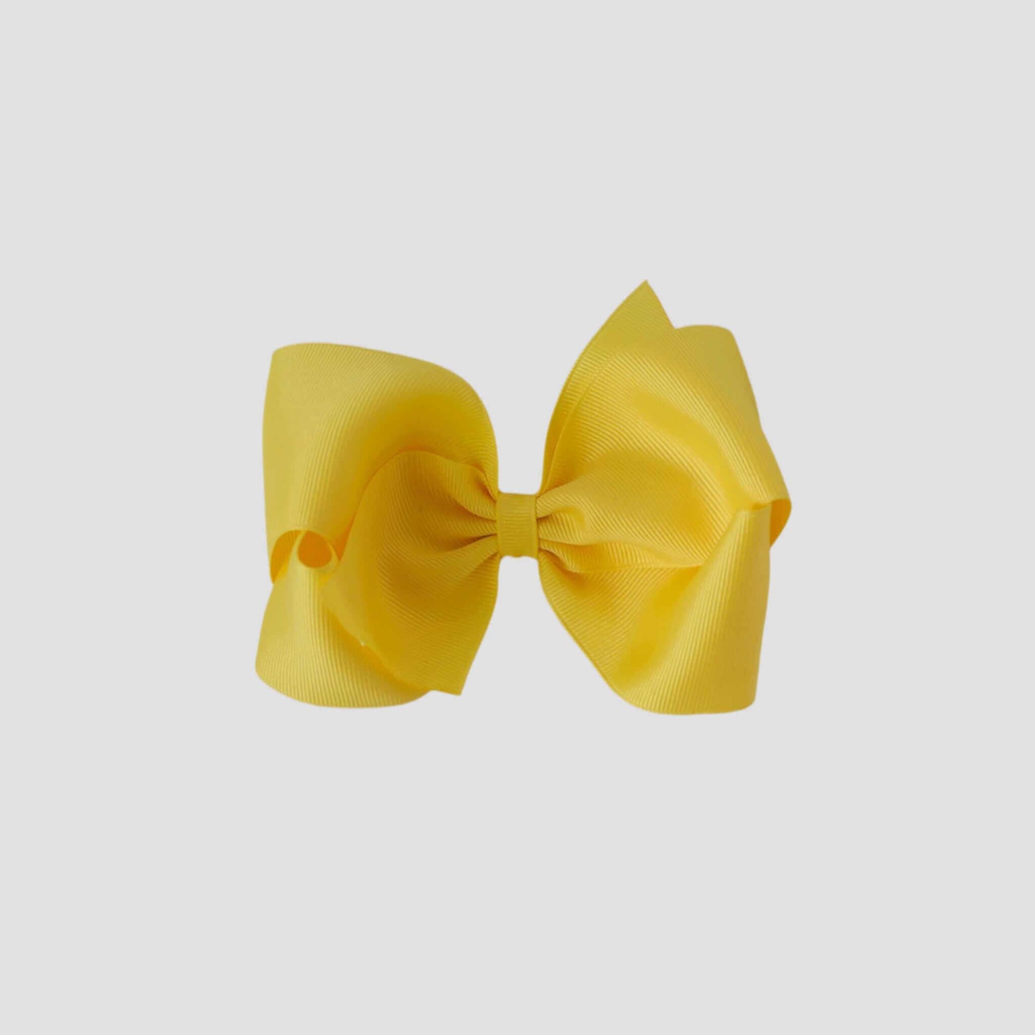 Yellow hair bow on a white background