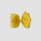Yellow hair bow on a white background