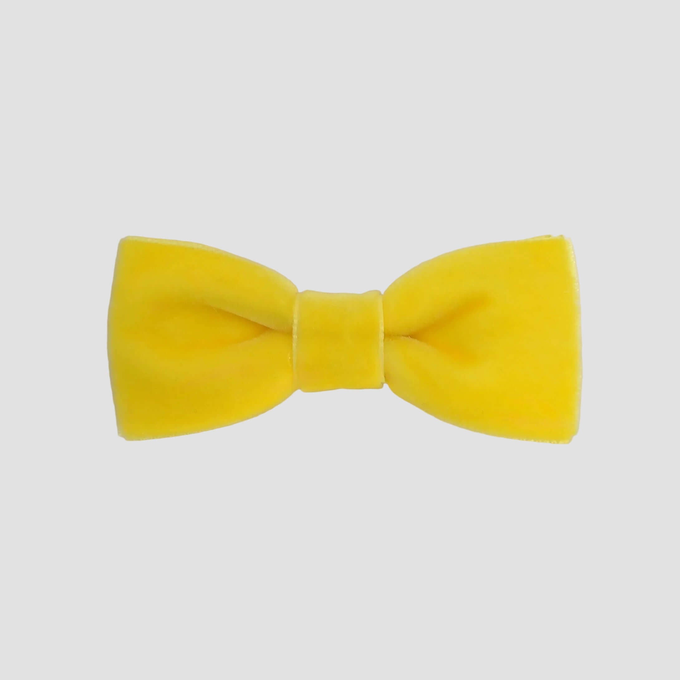 0-24 mos Yellow velvet bow tie on a white background