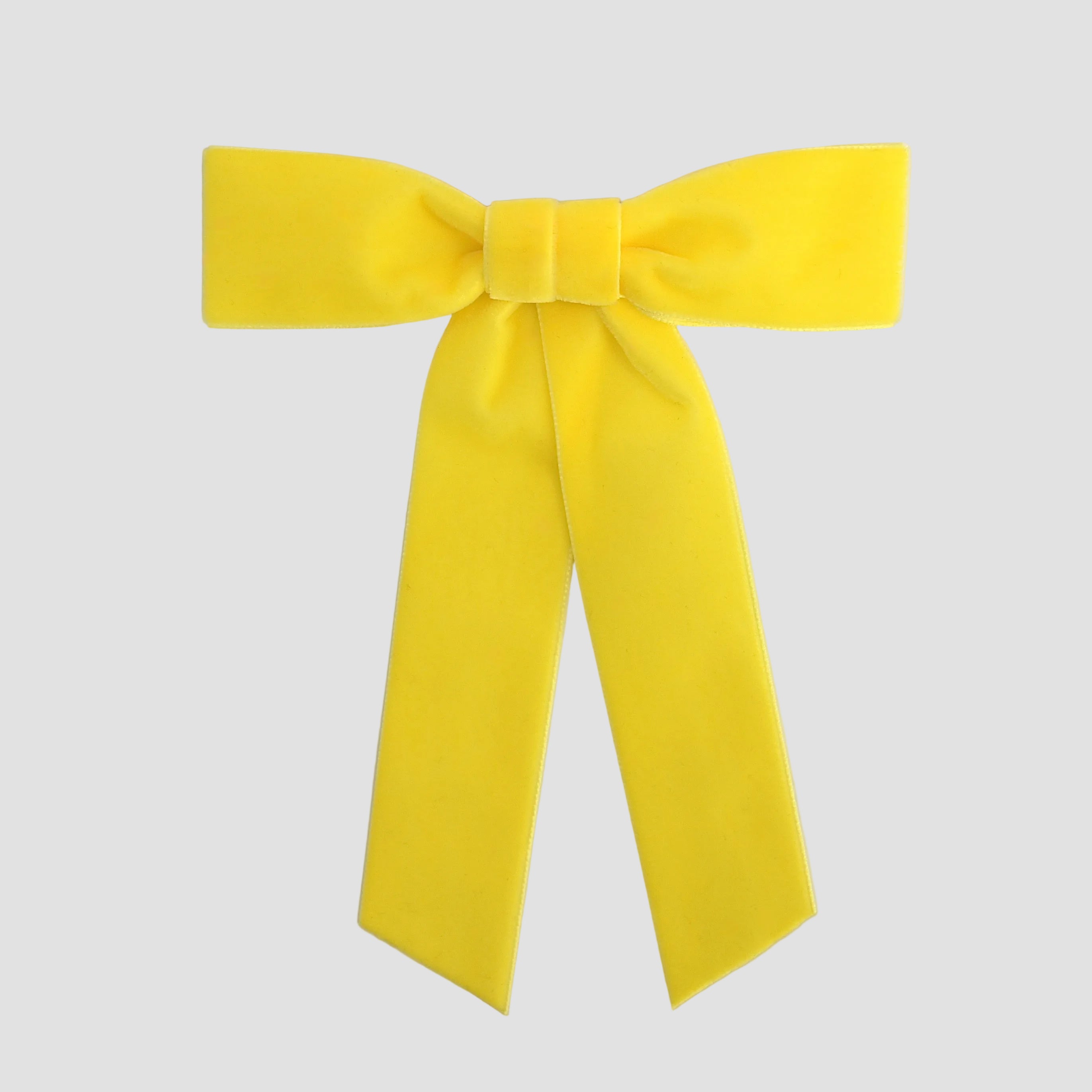 Yellow Zoe petite velvet hair bow on a white background.