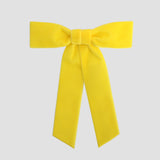 Yellow Zoe petite velvet hair bow on a white background.