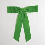 Apple green Grace velvet hair bow for women. Double bow with long tails on white background 