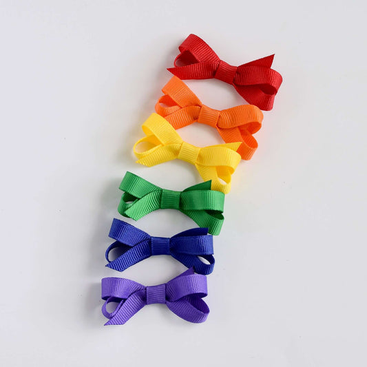 Rainbow colored grosgrain ribbon hair bows set for babies and toddlers with snap clips and no-slip grips, perfect for colorful accessorizing.