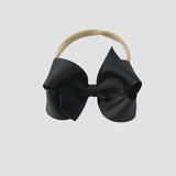 Black bow on a nude nylon headband 