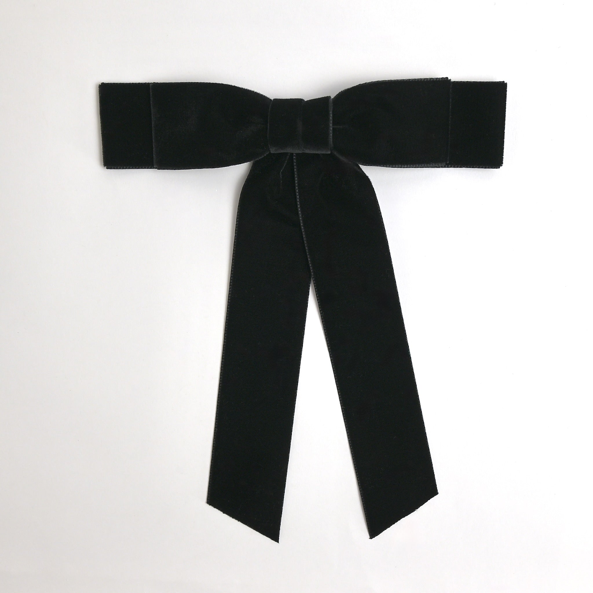Black Grace velvet hair bow for women. Double bow with long tails on white background 