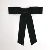 Black Grace velvet hair bow for women. Double bow with long tails on white background 
