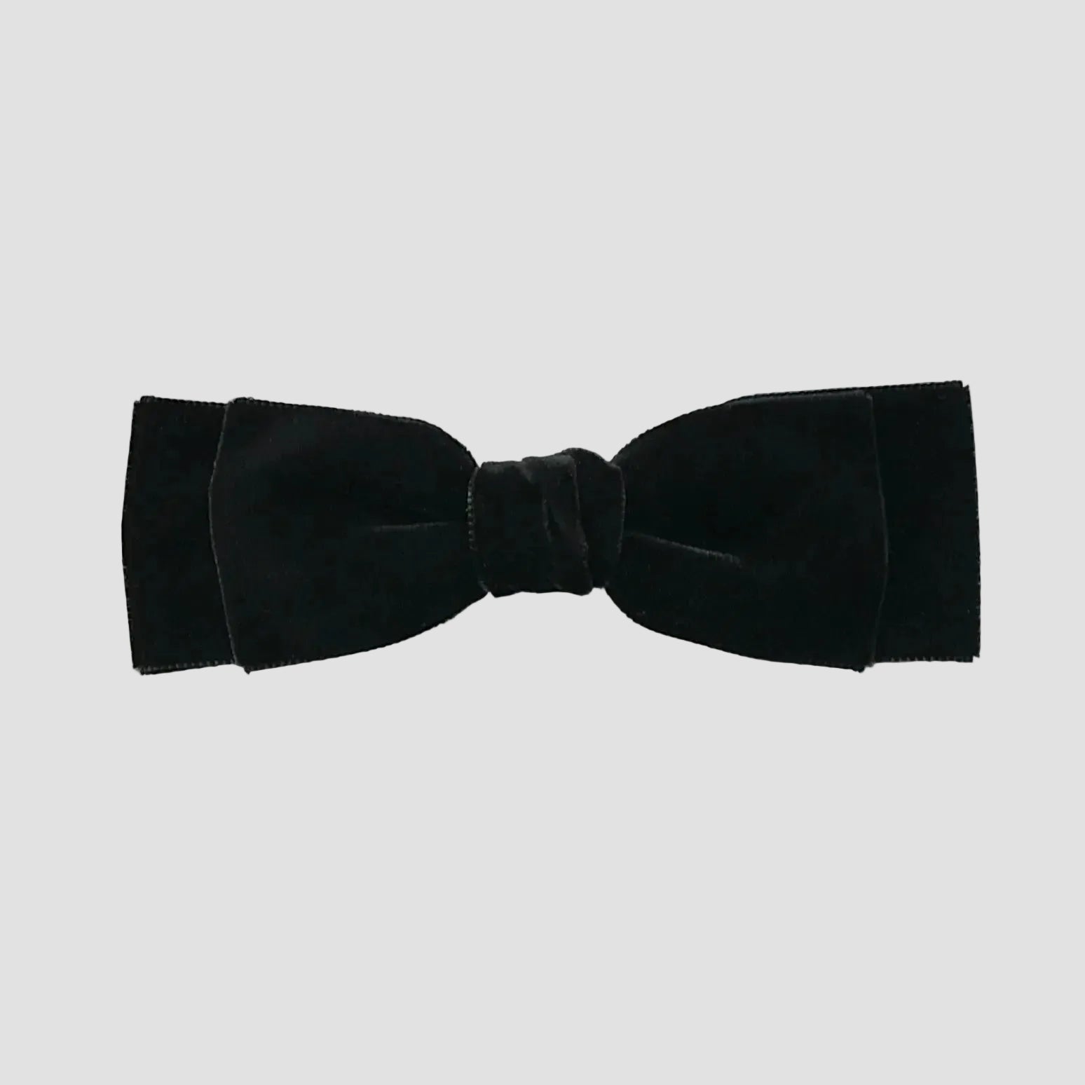 Black velvet hair bow on a white background
