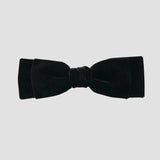 Black velvet hair bow on a white background