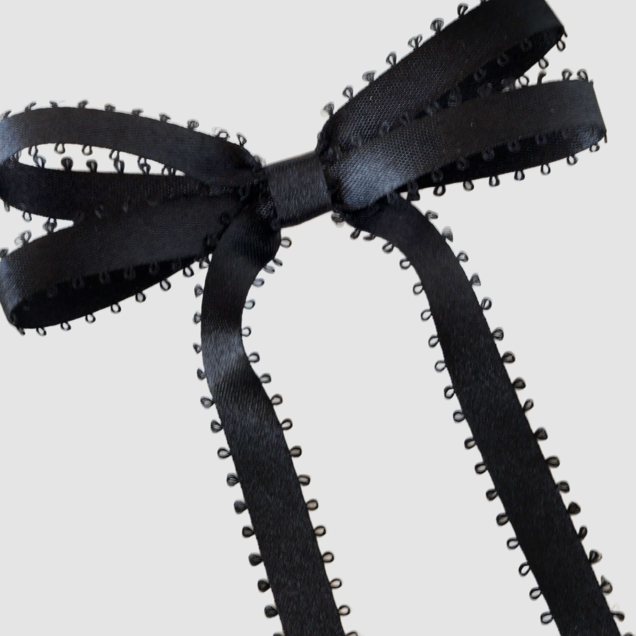 Olivia Picot Satin Bow in black with picot edges, a chic and elegant hair accessory for women and girls.