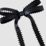 Olivia Picot Satin Bow in black with picot edges, a chic and elegant hair accessory for women and girls.
