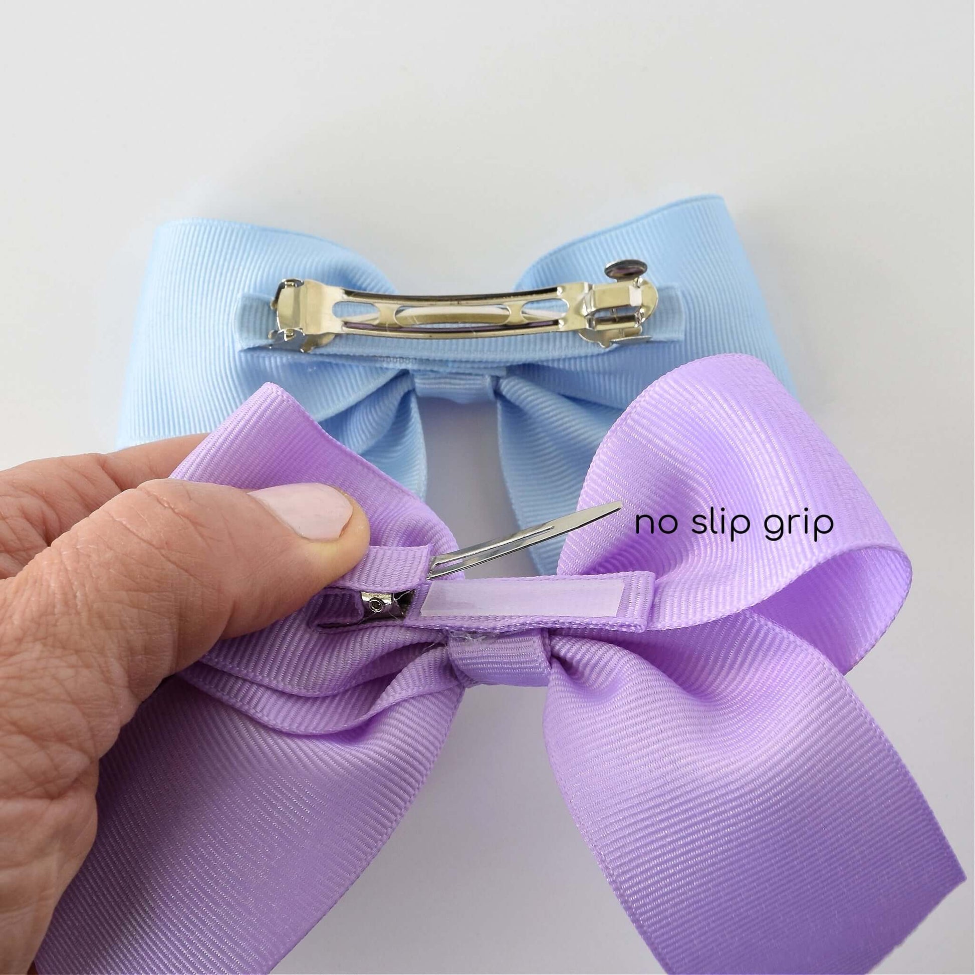 Purple and blue 4 inch grosgrain Sailor hair bows with alligator clip featuring no-slip grip.