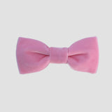 Blush pink velvet bow tie on a white background