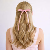 Blush Olivia velvet hair bow for women with long tails styled in half-up hairstyle