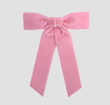 Blush pink Zoe petite velvet hair bow on a white background.