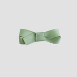 Celadon green bow on a white background