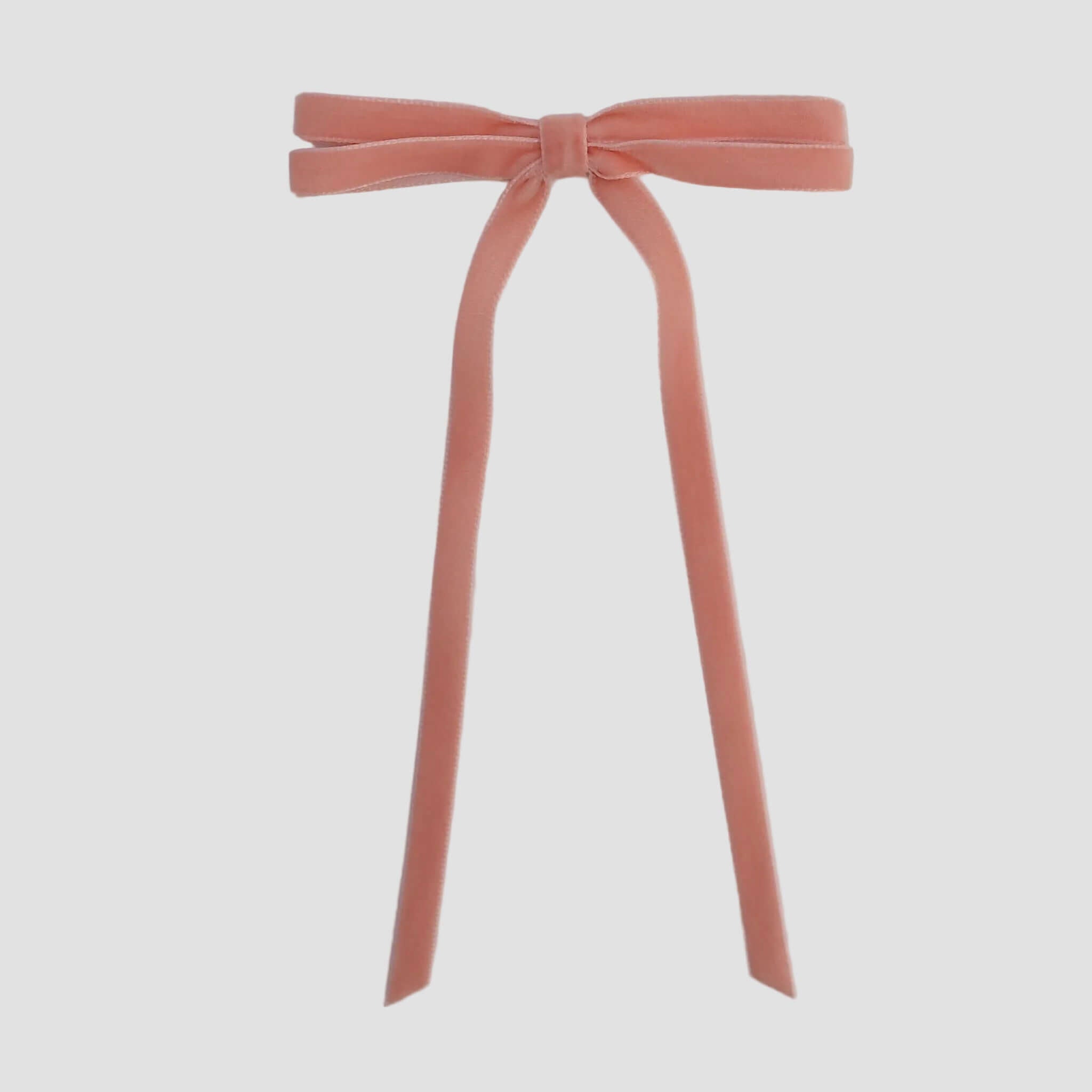 Coral Olivia velvet hair bow for women with long tails on white background