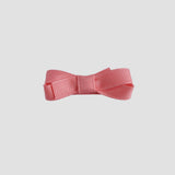 Coral bow on a white background
