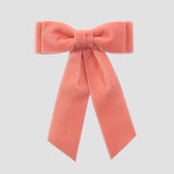 Coral orange velvet Mia bow on a white background