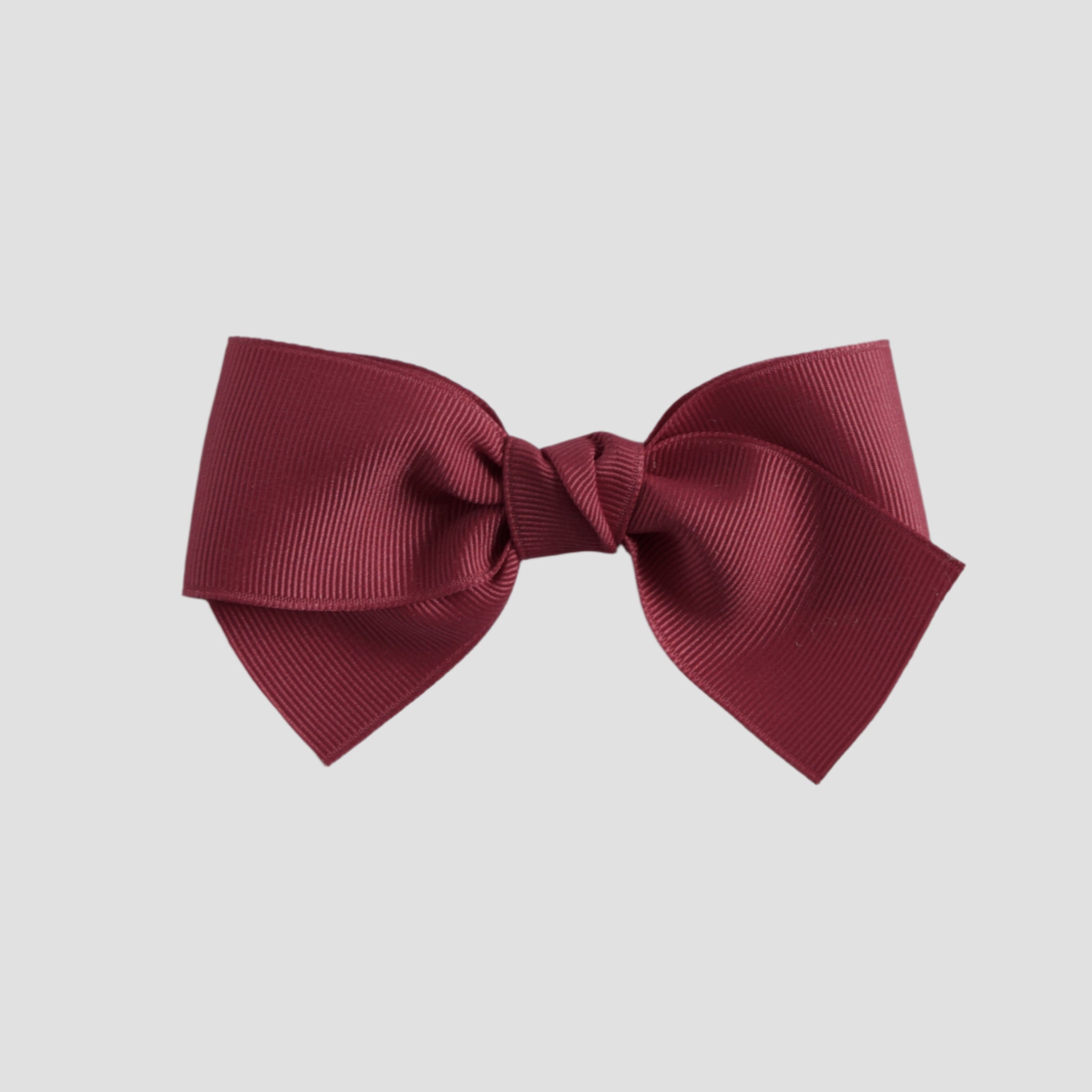 Cranberry red bow on a white background
