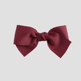 Cranberry red bow on a white background