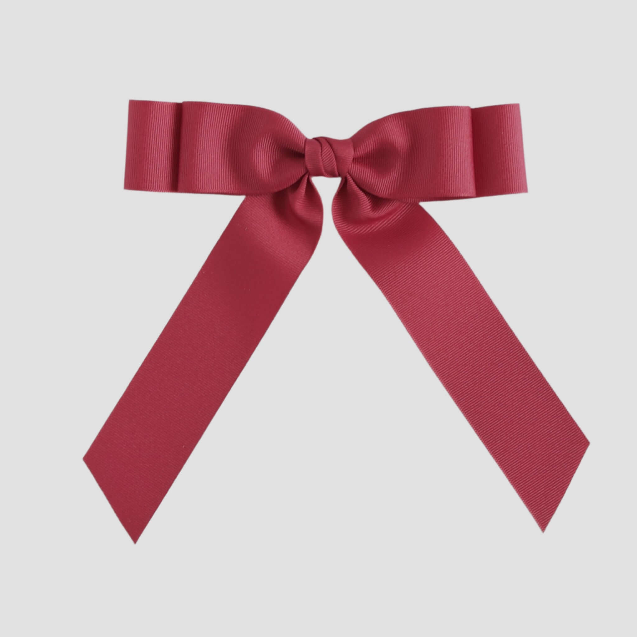 Cranberry red bow on a white background