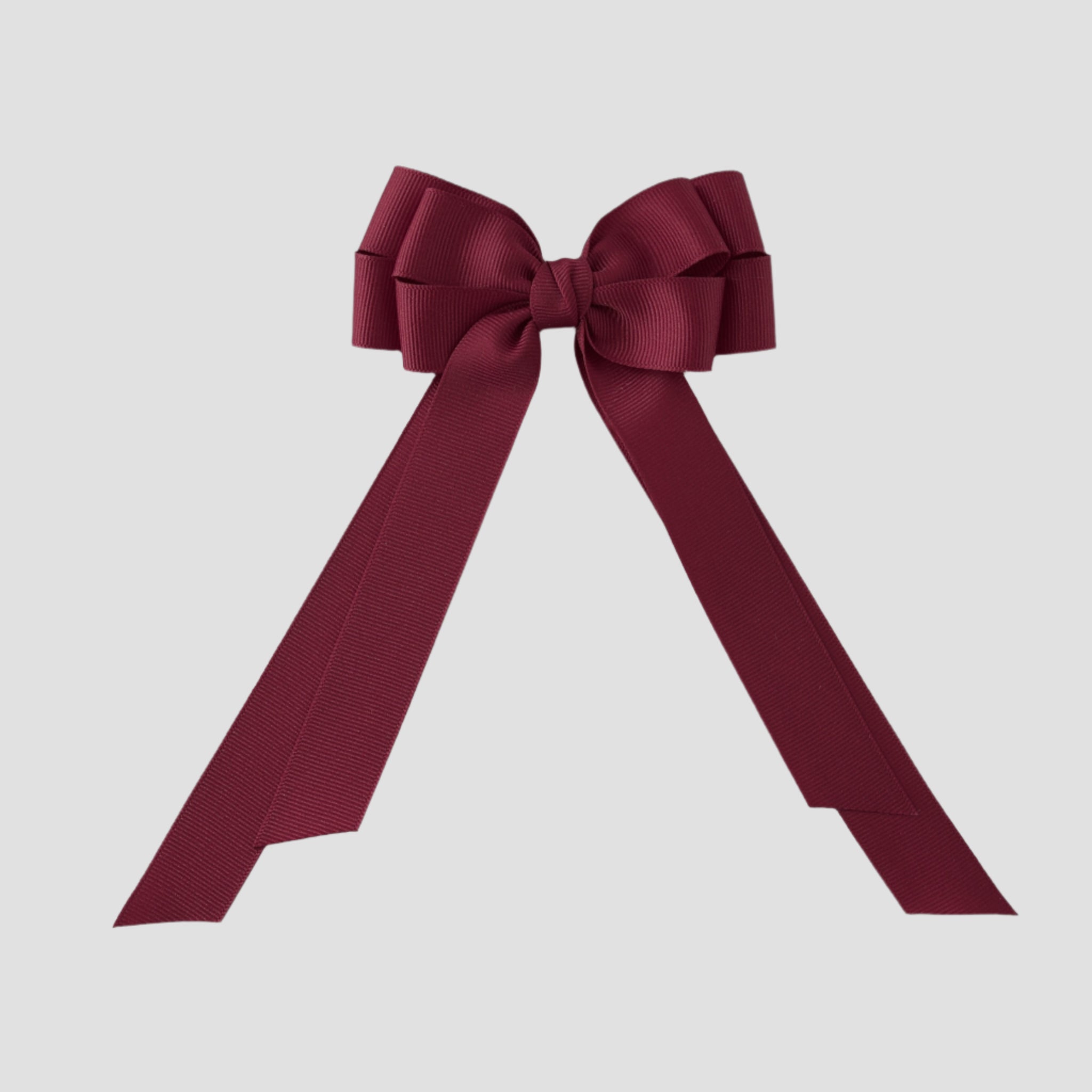 Cranberry red grosgrain Emerson bow on a white background
