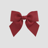 Cranberry red bow on a white background
