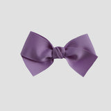 Dark orchid purple bow on a white background