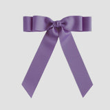 Dark orchid purple ribbon bow on a white background