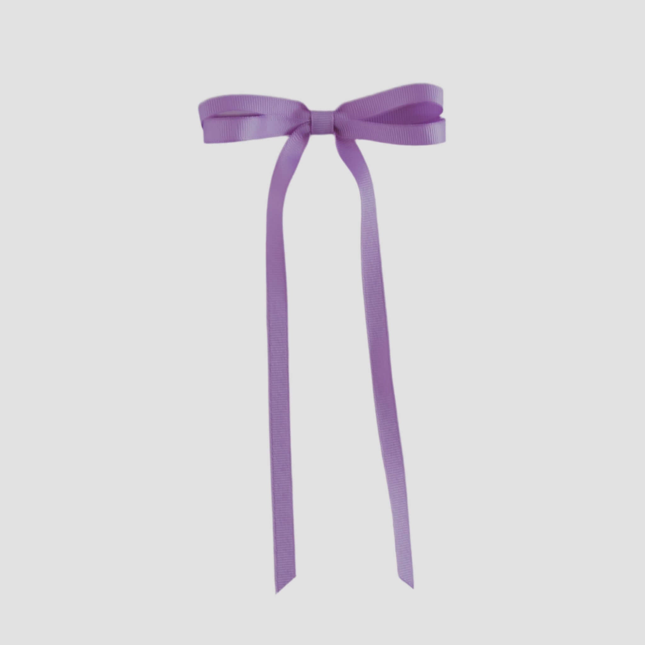 Dark orchid purple ribbon bow on a white background