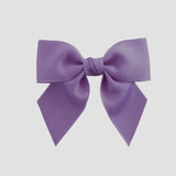 Dark orchid purple bow on a white background