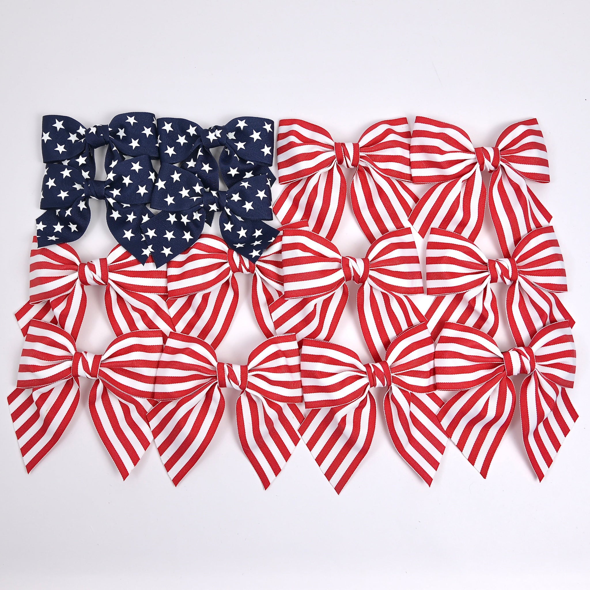 Set of red, white, and blue hair bows on a white background